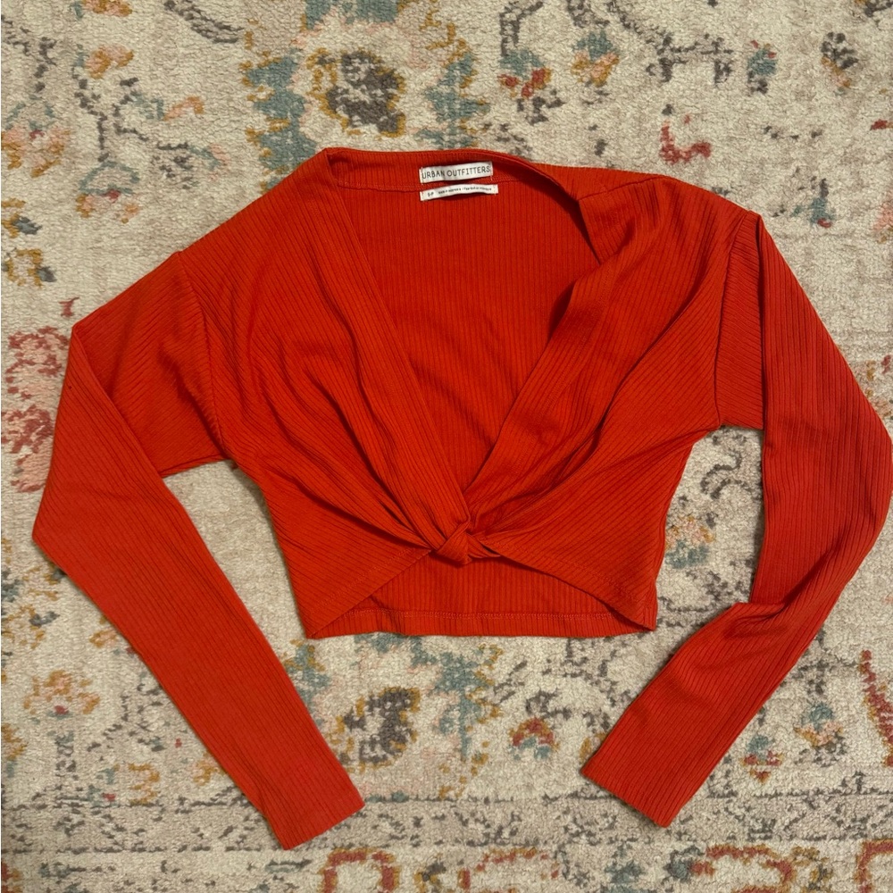 Orange knit crop top with a twist detail